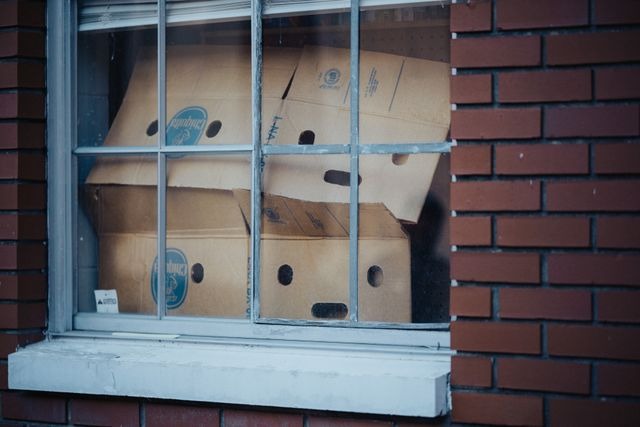 cardboard boxes stacked behind a window