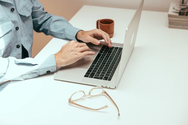 person at a desk using a laptop