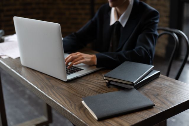 person at a desk using a laptop