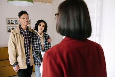 Three people meeting inside a property